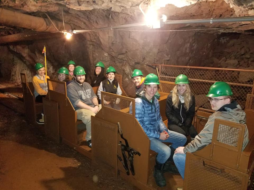 Bemidji State students visiting a Sudan mine and wearing green hard hats