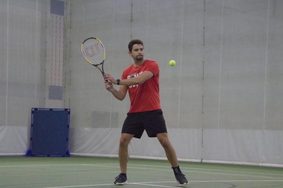 Student playing tennis in the recreation center