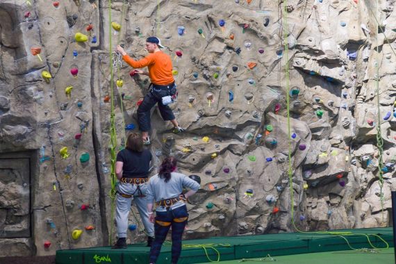 Students using a rock-climbing wall