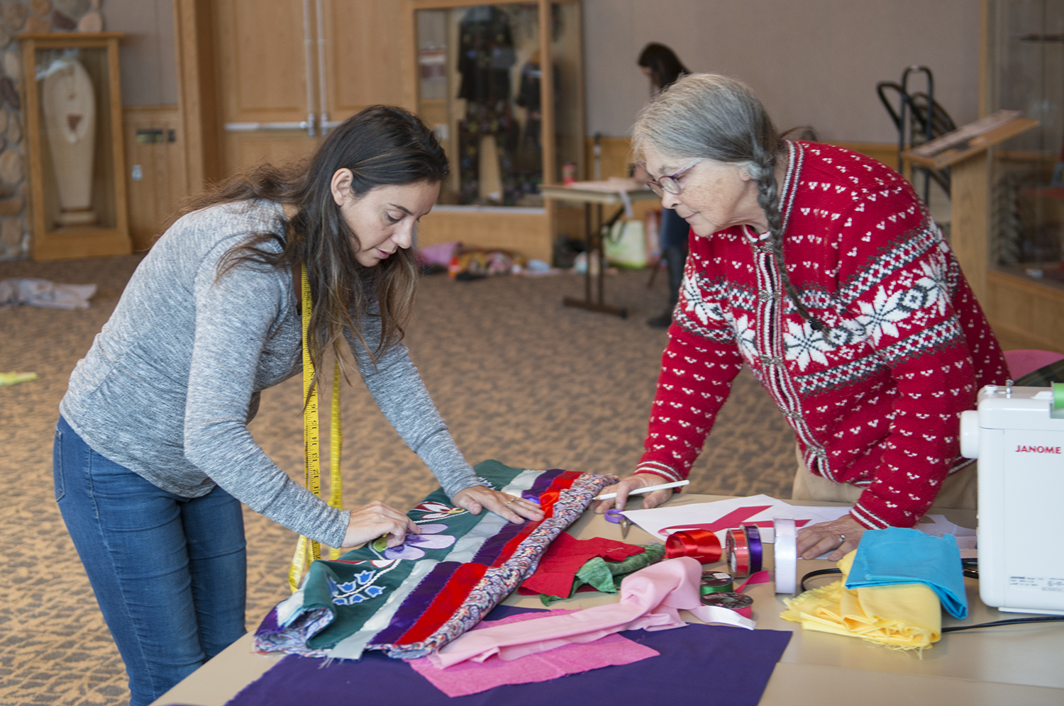 A student and a mentor making skirts in the American Indian Resource Center at Bemidji State University