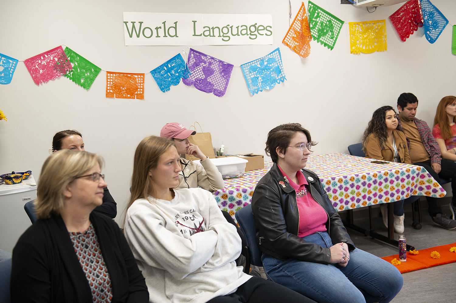 Day of the Dead celebrations and students sitting under a world languages banner