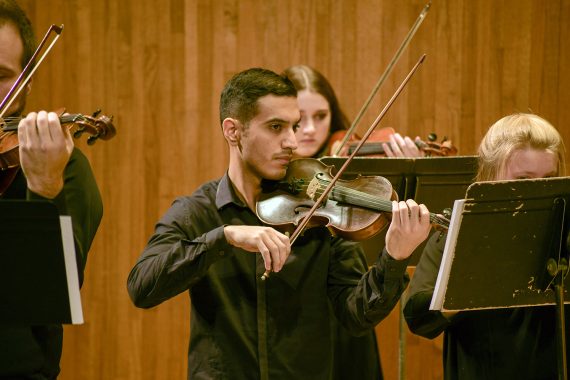 Bemidji State Chamber Orchestra violin players performing in 2022