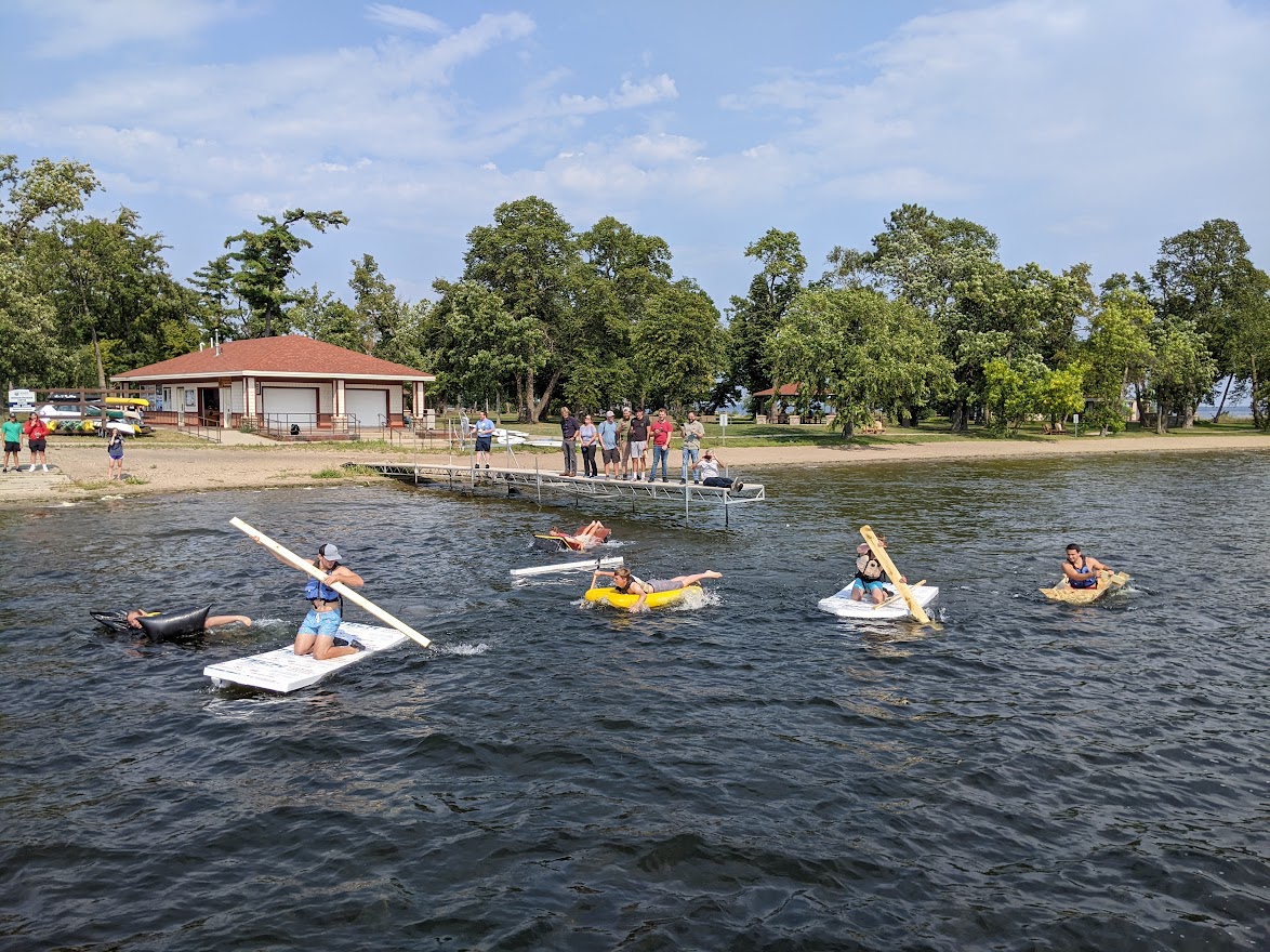 Bemidji State TAD Engineering students in boats they made for class, trying not to sink in Lake Bemidji