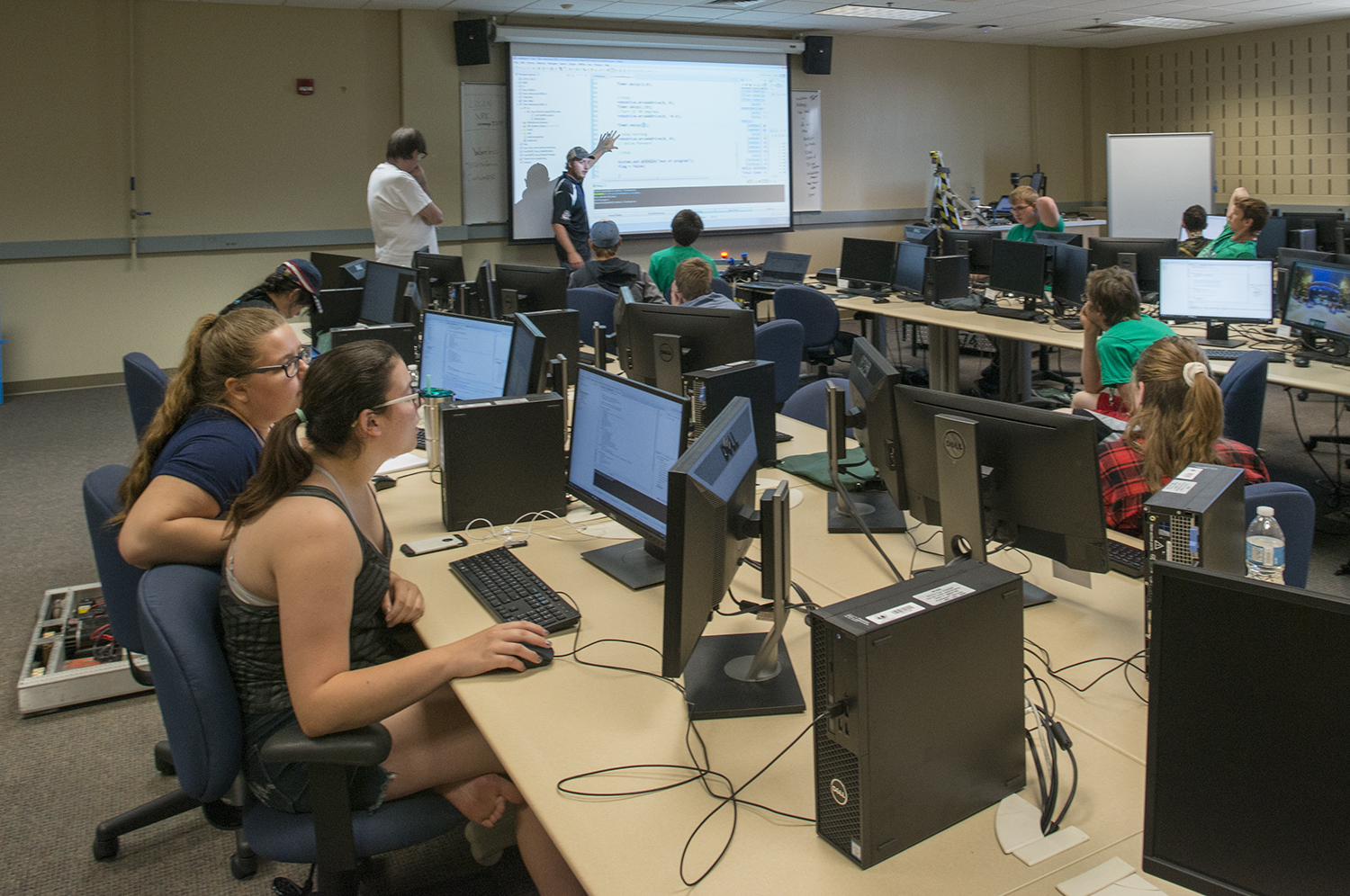 Technology, Art & Design students in a classroom, sitting in front of computers while a professor lectures