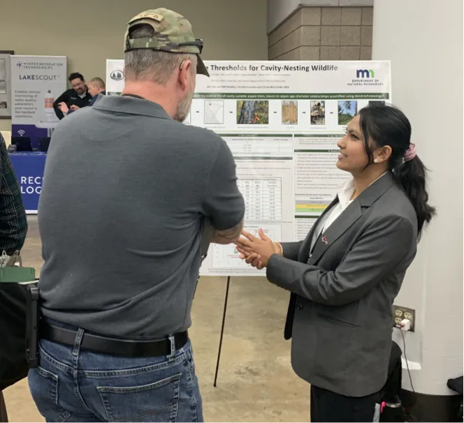 Student presenting her project to an attendee.