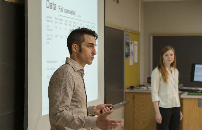 Jordan Lutz (left) and Anna Haynes explain their research into waste reduction in BSU's Dining Services.