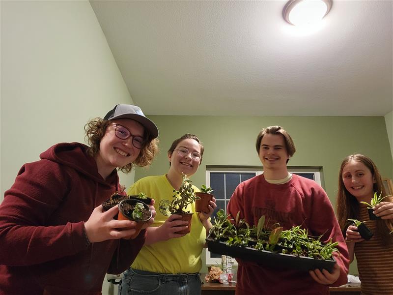 Honors students holding plants