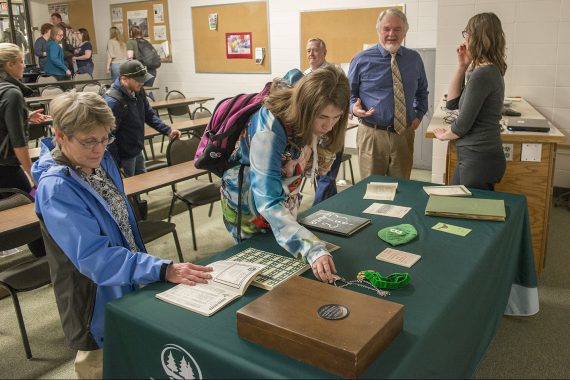 Honors students viewing artifacts at a honors lecture