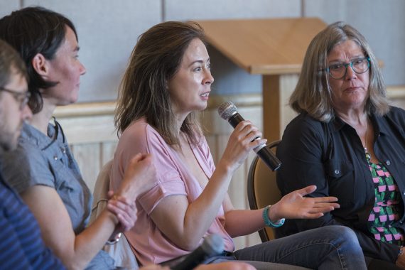 Northwoods Writers Conference panel discussion with a woman speaking into a microphone