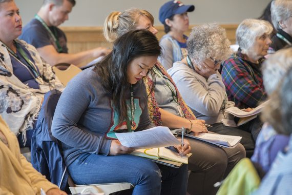 Northwoods Writers Conference audience members writing on notepads