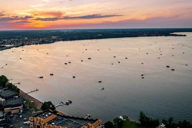 Lake Bemidji at sunset with boats on it