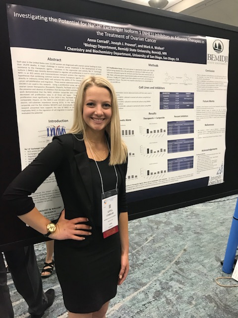 Student standing in front of a poster