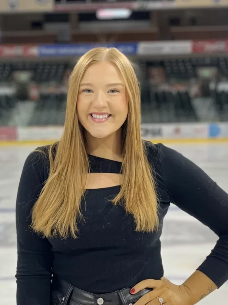 Headshot of Emily in an ice arena.