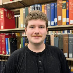 A person standing in front of books