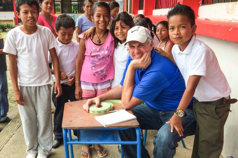 Mark Backlin and students siting at a table