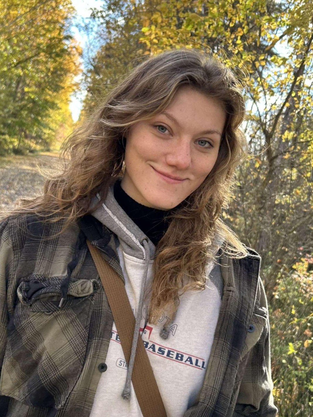 Student Lainie standing outside in a fall setting. 