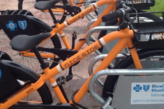 Go Green on an orange bike
