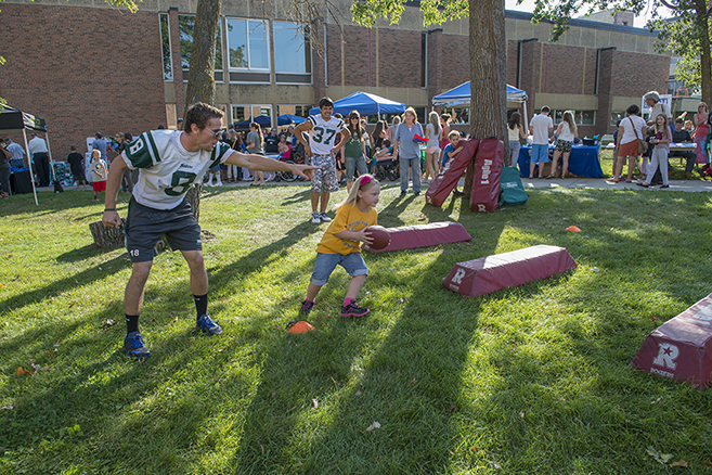 Football players guide young talent at Community Appreciation Day on Sept. 3.