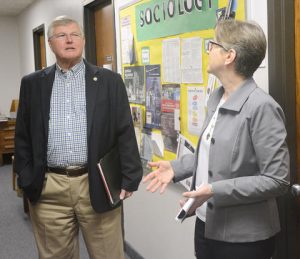 Sen. Tom Saxhaug, DFL-Grand Rapids, listen to Colleen Greer, dean of the College of Arts and Sciences at BSU, Thursday during a tour of faculty offices on the third floor of Hagg-Sauer Hall.