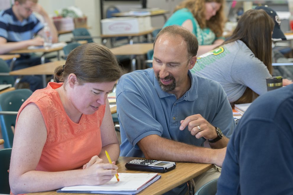 Frauenholtz (right) helps a student in Math Foundations