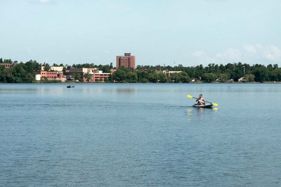 A student uses a kayak rented from BSU&rsquo;s Outdoor Program Center to paddle Lake Bemidji in 2012.