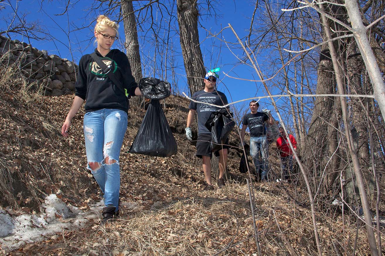 Students collect trash along the Lake Bemidji shoreline as part of Earth Day activities in April 2012.