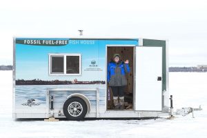 A student waves from BSU’s solar-powered Fossil Fuel-Free Fish House following its dedication on Jan. 28, 2017.