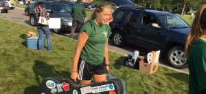 Senior soccer player Raquel Thelen assists a freshman during a busy Move-In Day on Aug. 18.