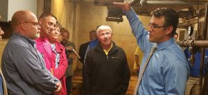 Director of Facilities Travis Barnes explains water damage in the basement of Hagg-Sauer Hall during an Aug. 16 tour for members of the Minnesota House Capital Appropriations Committee.