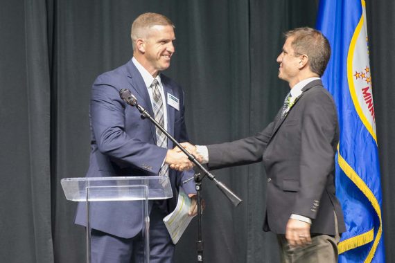 Alumni & Foundation Board President Ben McAninch congratulates Outstanding Alumni Jason Edens.