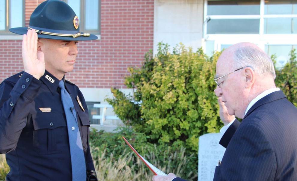 Nebraska Secretary of State John Gale administers the oath of office to John Bolduc '86 as the 18th superintendent of the Nebraska State Patrol on Oct. 16 in Lincoln, Neb.