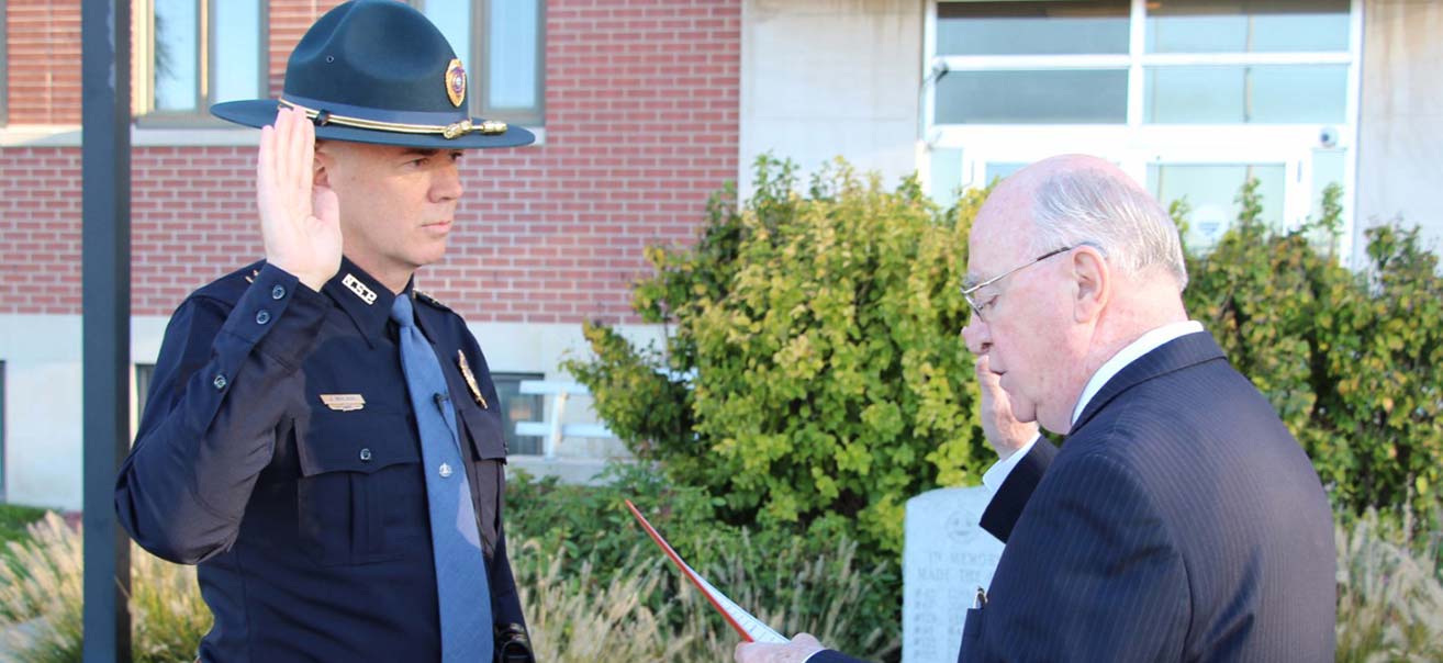 Nebraska Secretary of State John Gale administers the oath of office to John Bolduc '86 as the 18th superintendent of the Nebraska State Patrol on Oct. 16 in Lincoln, Neb.