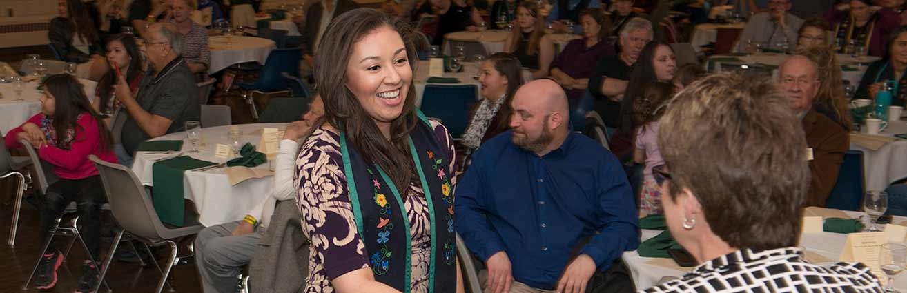 Naomi Johnson was greeted by President Hensrud after receiving her commencement stole at the American Indian Students Recognition Banquet on April 19.