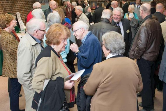 Nancy Bensen, foreground at left, wife of President Emeritus Jim Bensen, was among guests at an April 12 &ldquo;History Walk&rdquo; reception in the lobby of the Main Stage theater at the Bangsberg Fine Arts Complex.