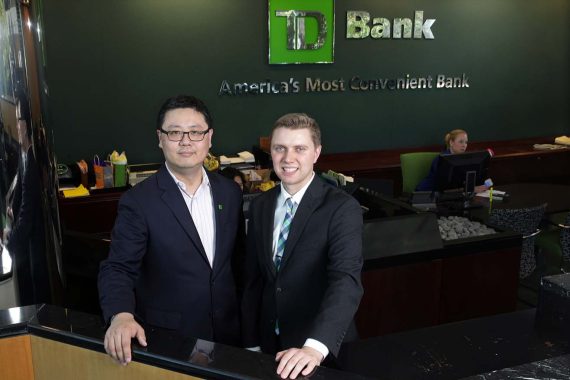 Toronto-Dominion Bank employees and Bemidji State University graduates Xihao Hu, left, and Peter Hills stand together inside the headquarters of TD Bank where they work, Thursday, May 24, 2018, in Cherry Hill, N.J. (Photo/Mel Evans)