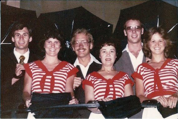 Students perform “Singing in the Rain” during a late-1970s Funtastic Dance Follies performance, joined by director Marion Christianson, center.