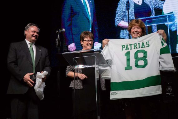 President Faith Hensrud presents a Beaver Hockey jersey to Marla Patrias for her 20 years of service with the BSU Alumni & Foundation.
