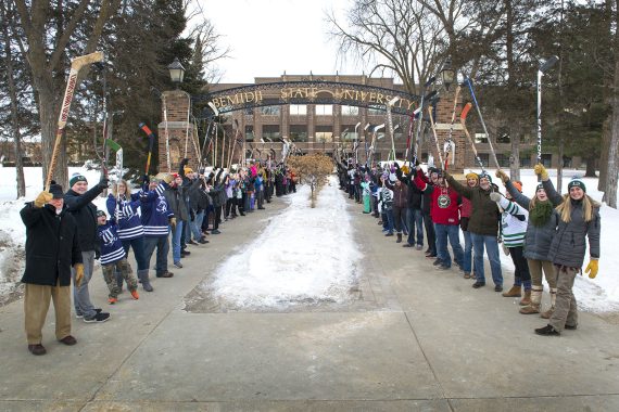 “World’s Largest Hockey Stick Salute” Draws 100 People in Honor of Hockey Day Minnesota 100 people came together to show their Hockey Day Minnesota pride today on the BSU campus.