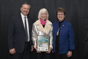 Tracy Dill, director of athletics, and President Faith Hensrud pictured with Muriel Gillman.