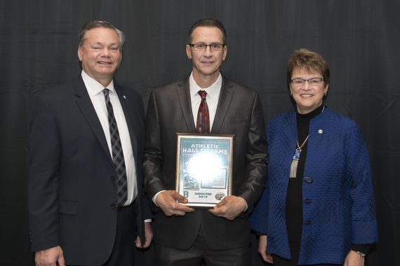 Tracy Dill, director of athletics, and President Faith Hensrud pictured with Rich Swartz.
