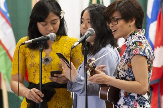 Students playing the ukulele and singing at the 50th annual Festival of Nations celebration.