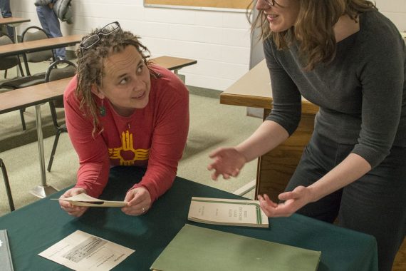 Colleen Deel and Mary Overlie examine artifacts following Deel's Honors Council Lecture on the university archives