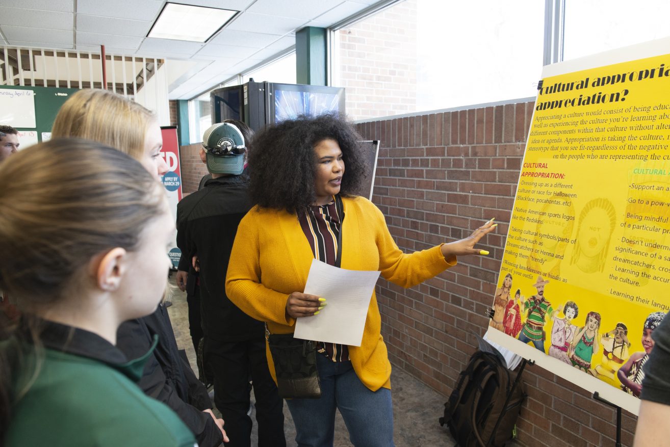 A student presenting her poster at the Student Achievement Conference