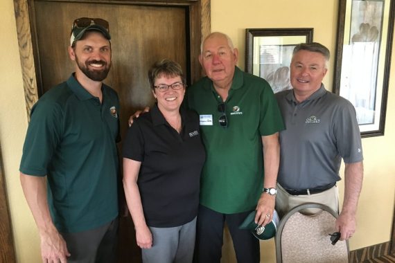 President Hensrud with three BSU alumni.