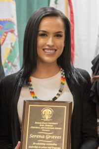 Serena Graves with a plaque for the Earl Nyhom Cultural and Language Award.