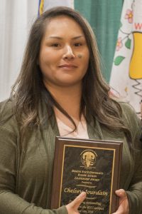 Chelsey Jourdain with a plaque for the Roger Aitken Leadership Award.