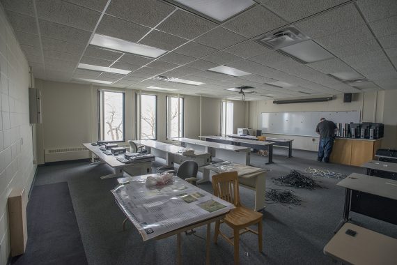Computers and other equipment being moved out of a classroom.