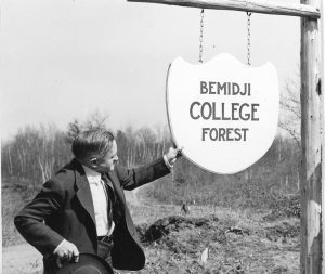 Dr. Claude Vivian “Mr. Conservation” Hobson and the first school forest sign.