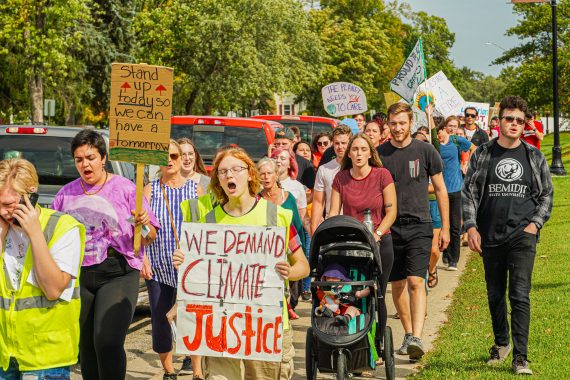 Participants walking to the Paul Bunyan Park during the climate march.
