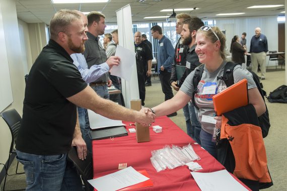 Exploring Local Careers: Students Connect with Technology, Art and Design Experts Alana Feser, freshman from River Falls, Wisc., meets Jaran Sharp, full service industrial contractor at Fagen Inc.